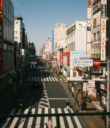 A busy street in a japanese city with many signs.